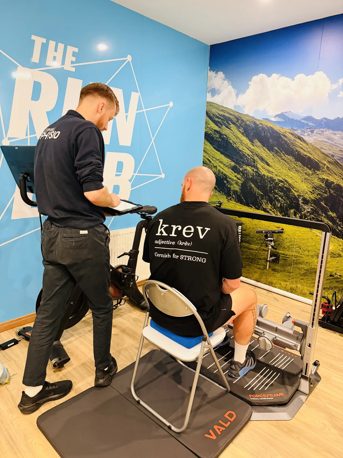 A Cornwall Physio physiotherapist recording an athlete's hamstring strength test on the VALD® ForceFrame in The Run Lab®